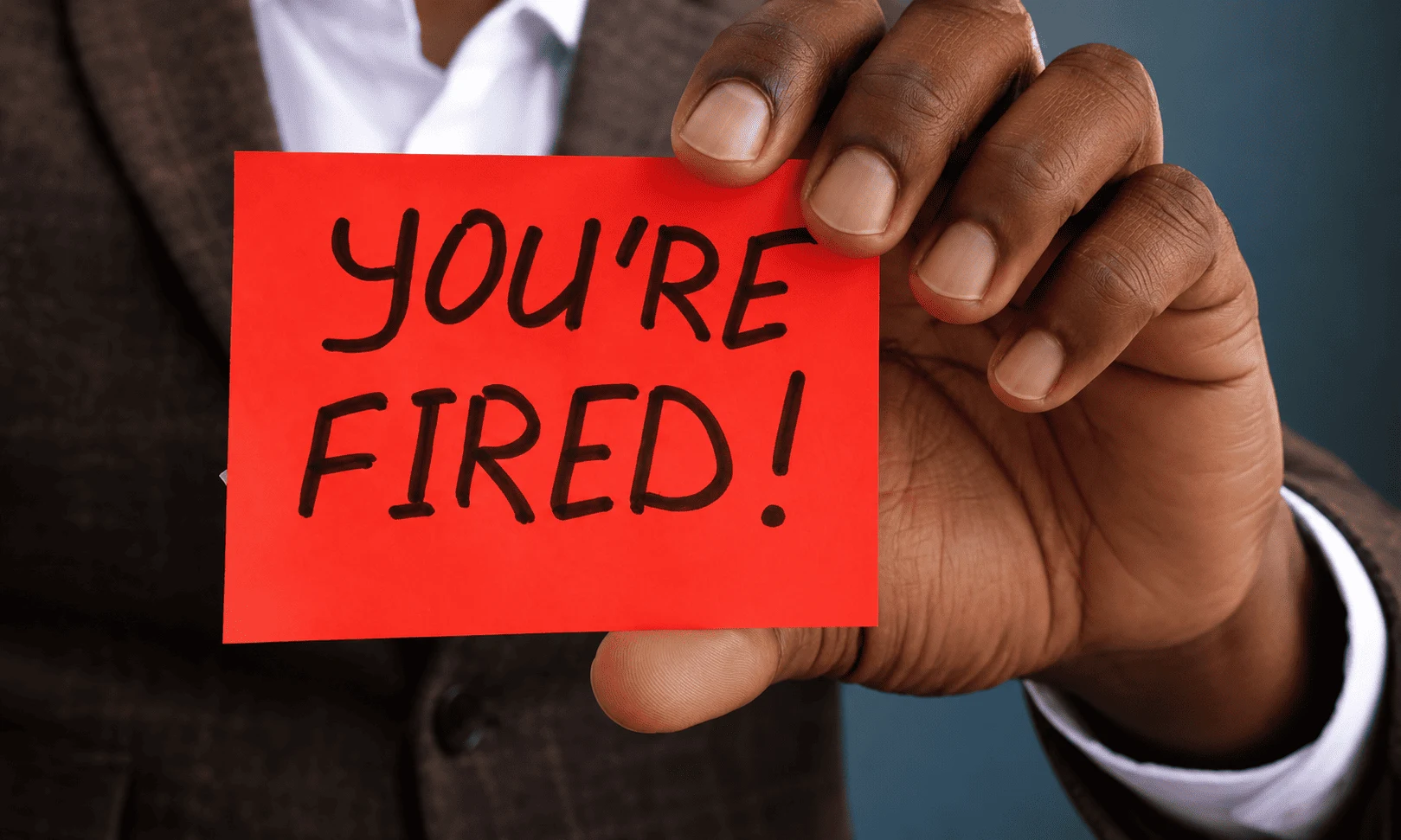 an employee reading a termination letter, alt text "Compensation for unfair dismissal in Kenya — what the Employment and Labour Relations Court actually awards